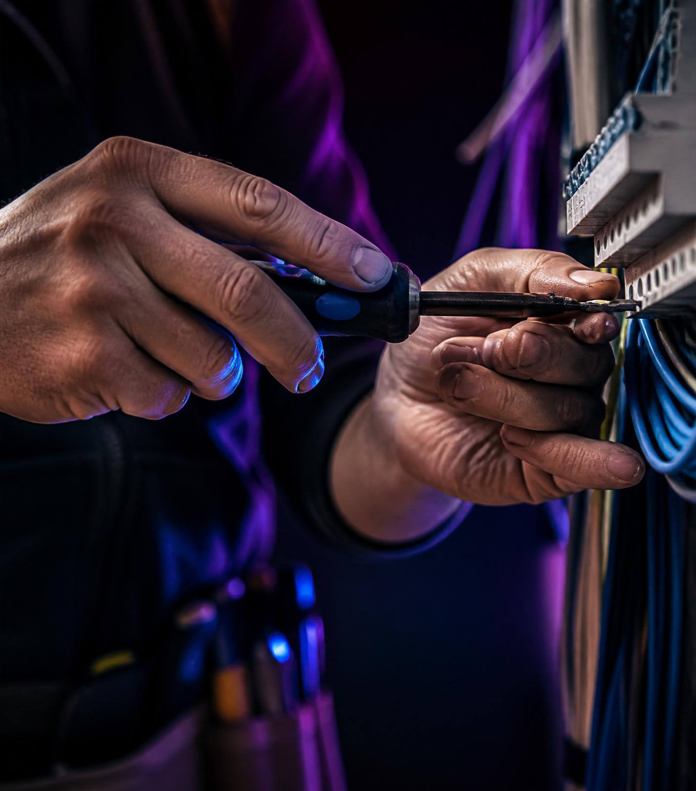 Qualified electrician working with precision tools